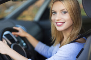 Smiling woman sitting in car