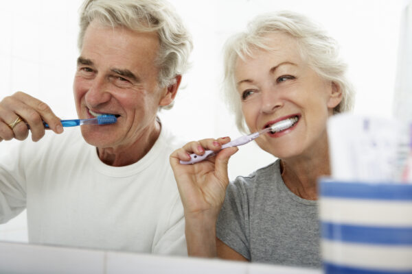 Couple Brushing Teeth